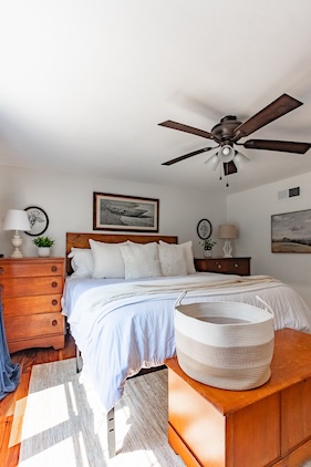 bedroom with basket used as a cleaning hack for minimizing clutter