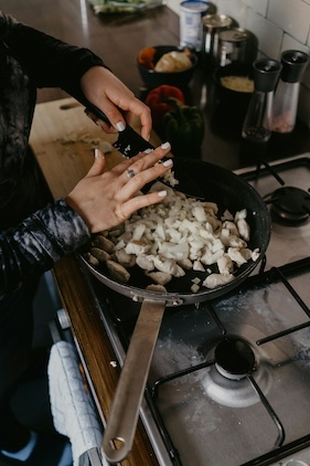 quick meal planning cooking being done on the stovetop, a woman is cooking chicken