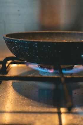 a pan sitting over an open flame on a stovetop