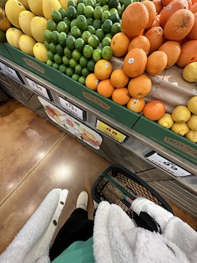 woman shopping for fruit in a grocery store