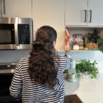 Busy mom using kitchen gadgets for meal prep in modern kitchen